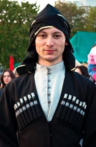 Kabardian man Eurasian child holding a baby animal